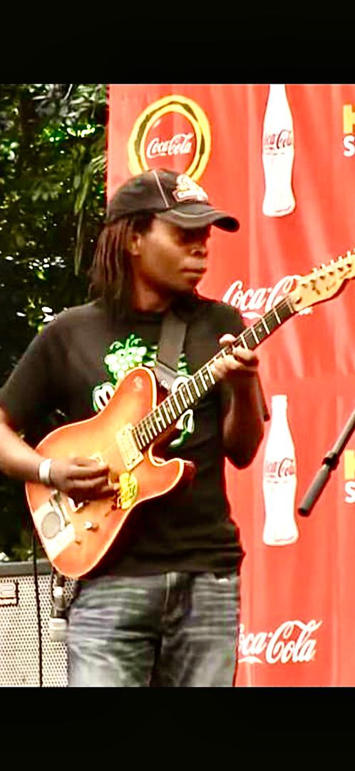 Guitarist performing at a live outdoor event